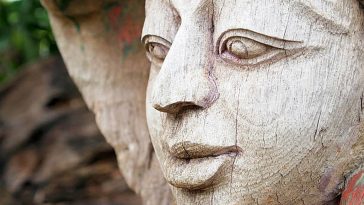 beautifully carved wooden face with expressive features