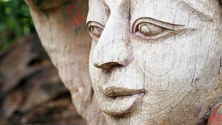 beautifully carved wooden face with expressive features