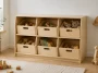 Finished DIY toy storage organizer with six removable wooden bins in a bright playroom