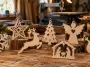 Handmade Christmas scroll saw patterns displayed on a woodworking bench