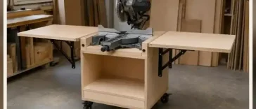 Finished mobile miter saw stand with birch plywood cabinet, open folding wings and locking casters in a garage workshop