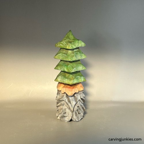 Wooden bearded gnome with a green tiered Christmas-tree hat
