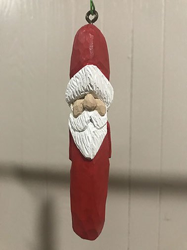 Painted red Santa ornament with a white beard and hanging loop