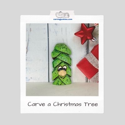 Green Christmas tree caricature carving with a large nose