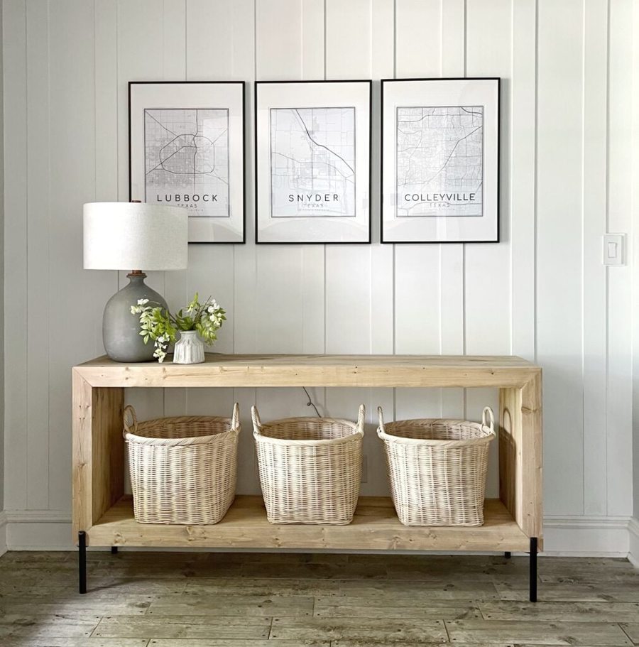 Modern waterfall console with baskets on the lower shelf