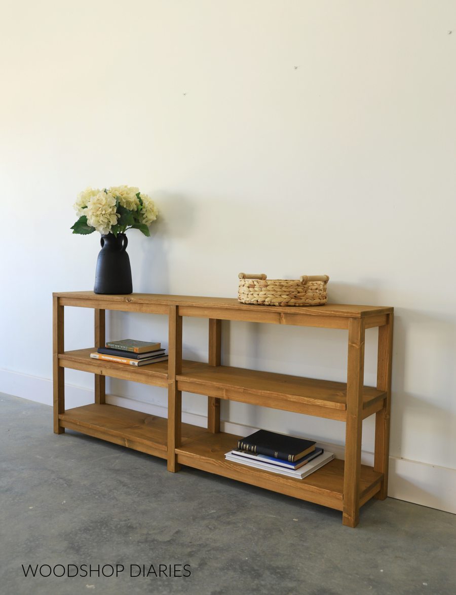 Low narrow console shelf with open storage compartments