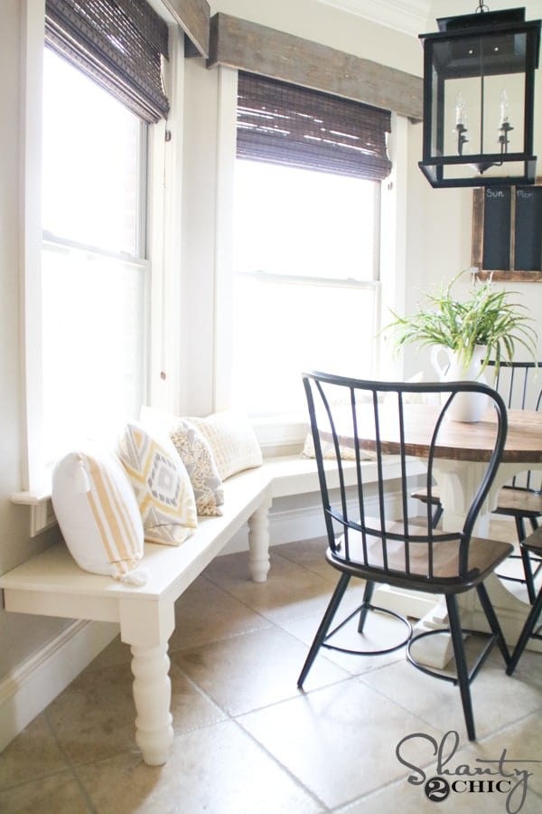 Angled white wooden bench following a bay window