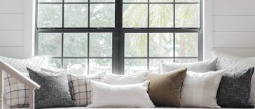 White built-in reading bench with three drawers below a window