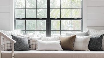 White built-in reading bench with three drawers below a window