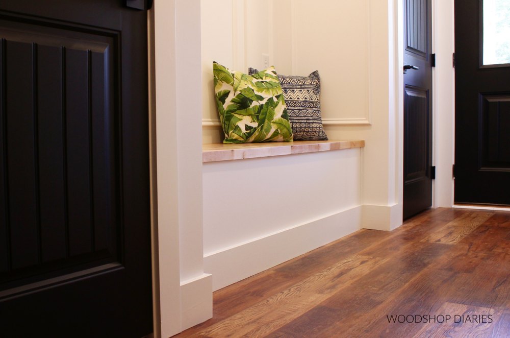 Painted built-in alcove bench with a wooden flip-top seat