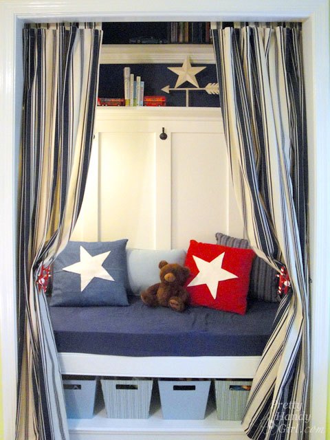 Closet reading bench with blue cushion and lower storage shelf