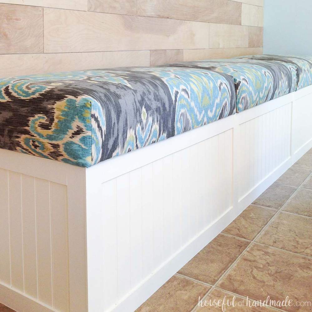 Long white storage bench with patterned removable upholstered tops