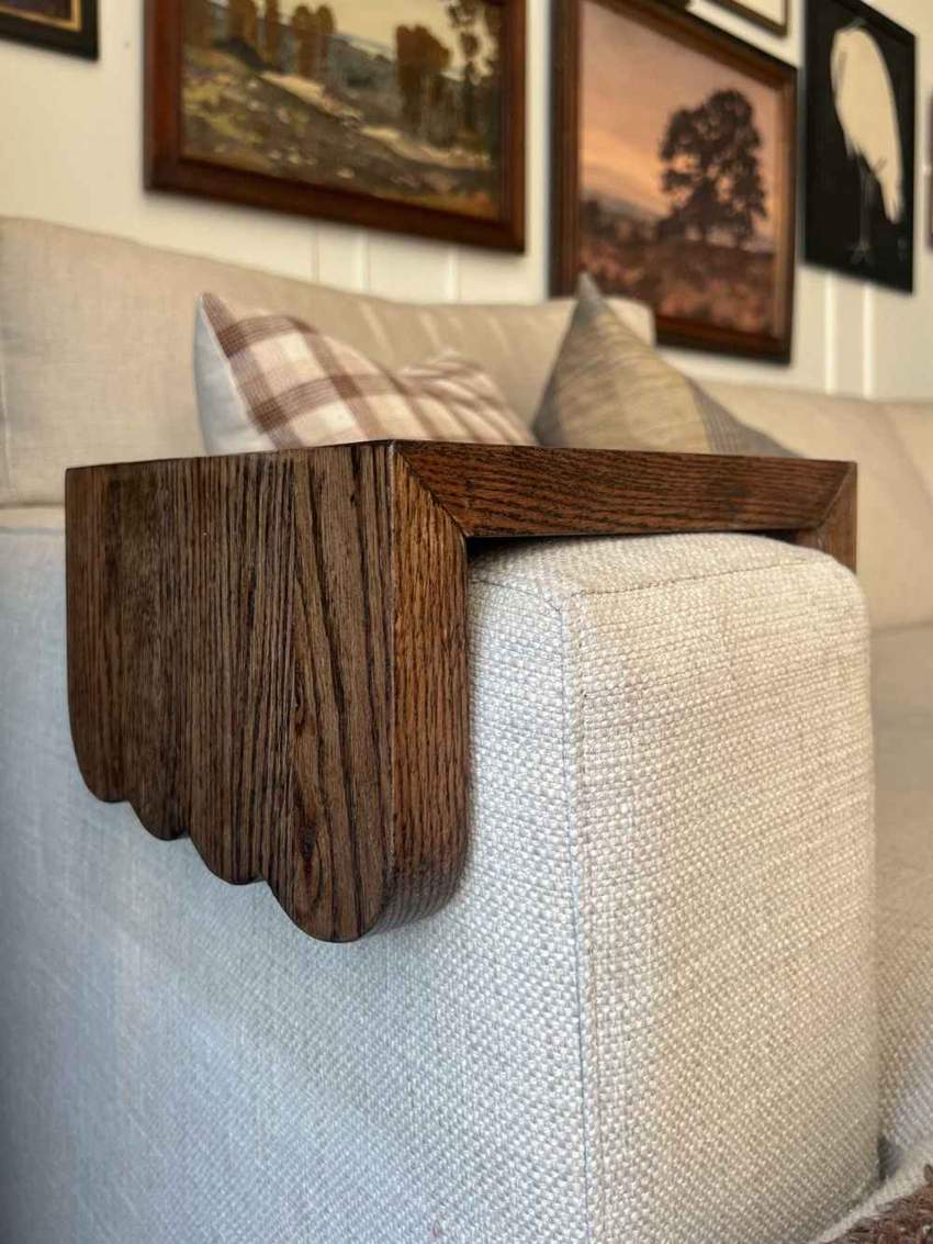 Scalloped oak tray fitted over a light upholstered sofa arm