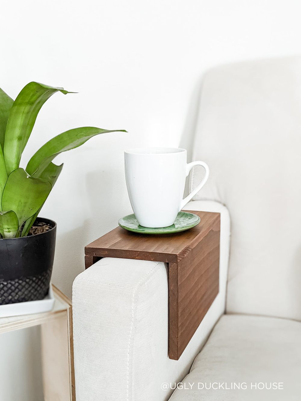 Simple dark pine sleeve over a white sofa arm