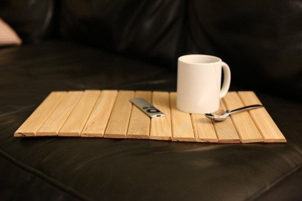 Oak roll-up sofa tray with a mug on top