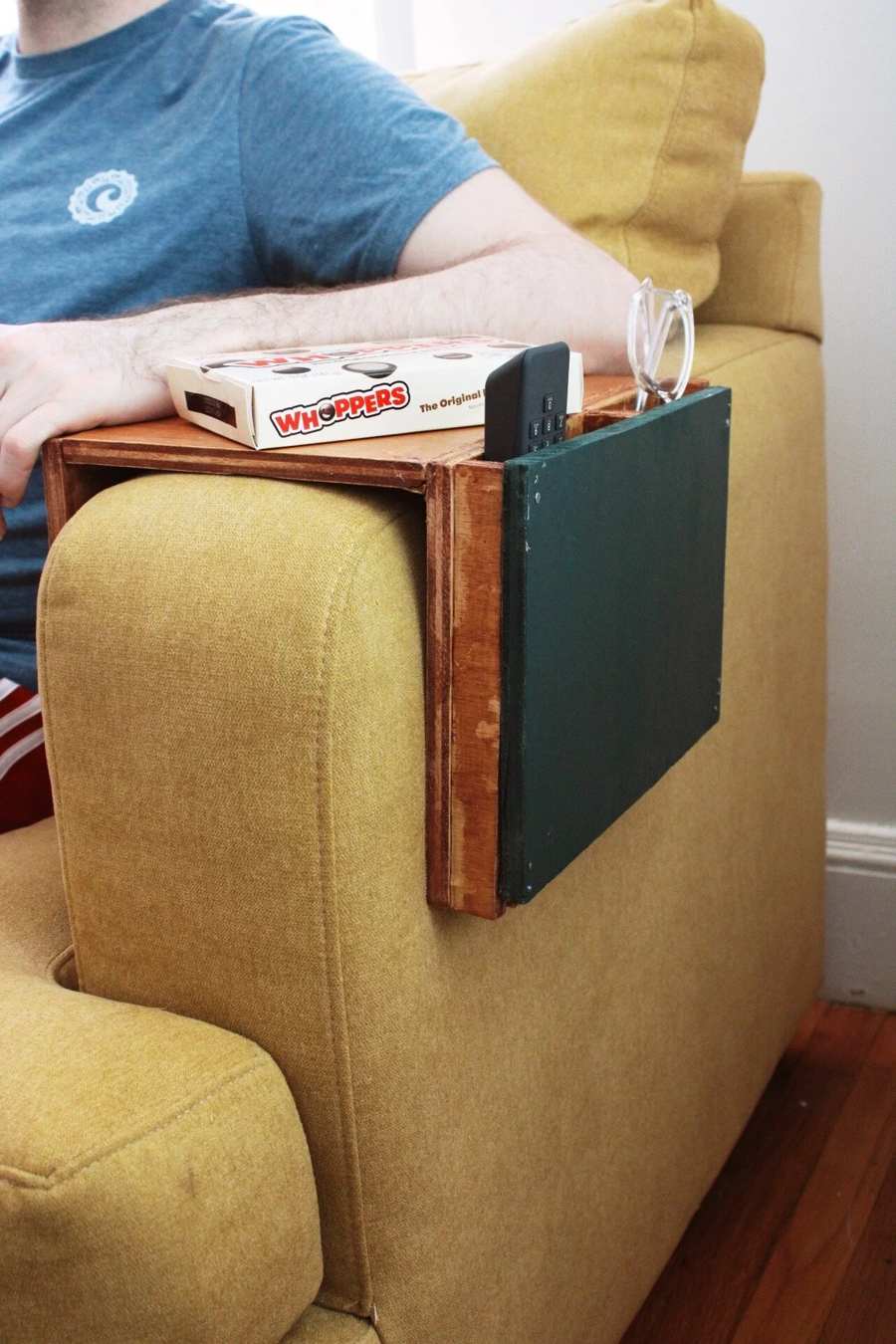 Wooden sofa sleeve with green side pockets for remotes and glasses