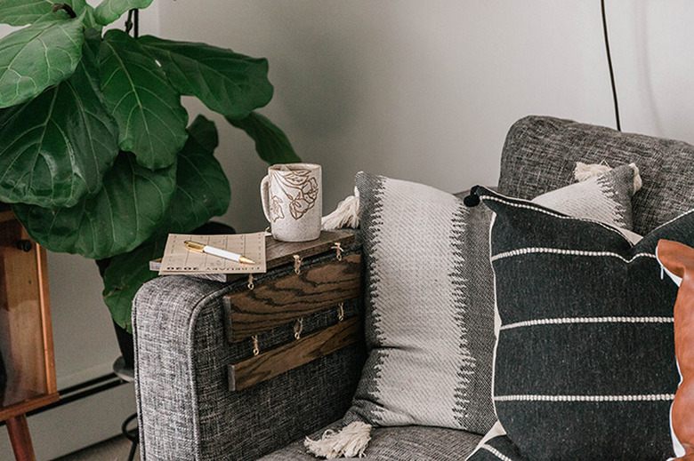 Five-panel wooden tabletop draped over a sofa arm